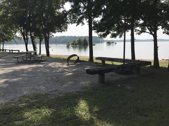 A photo of Site 107 of Loop LOOJ at Holiday (Georgia) with Picnic Table, Electricity Hookup, Fire Pit, Shade, Waterfront, Lantern Pole, Water Hookup