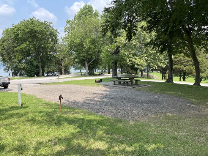 A photo of Site 037 of Loop LAKE at DEFEATED CREEK PARK with Picnic Table, Electricity Hookup, Fire Pit, Shade, Water Hookup