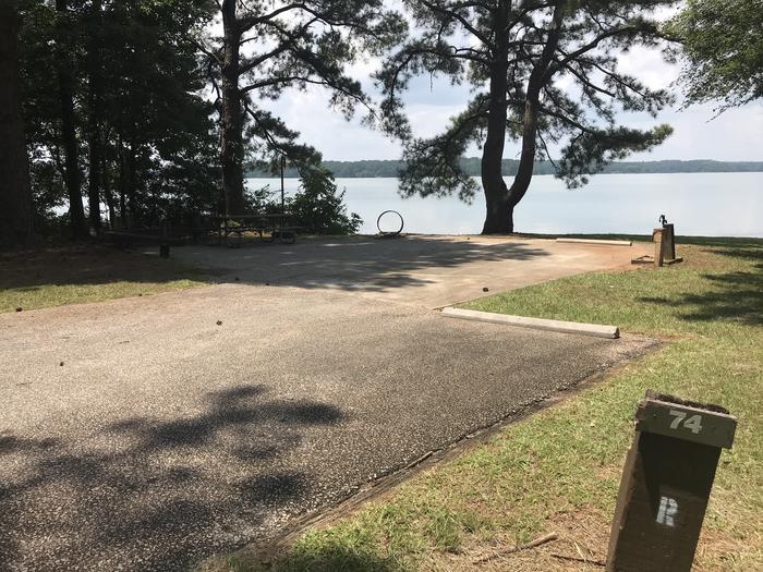 A photo of Site 074 of Loop LOOG at Holiday (Georgia) with Picnic Table, Electricity Hookup, Fire Pit, Shade, Waterfront, Lantern Pole, Water Hookup
