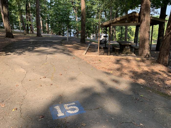 A photo of Site 15 of Loop QCOV at QUARRY COVE with Picnic Table, Electricity Hookup, Fire Pit, Shade, Lantern Pole, Water Hookup