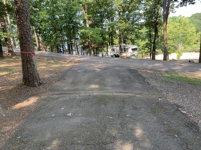 Showing exit from top of pad.A photo of Site 15 of Loop QCOV at QUARRY COVE with Picnic Table, Electricity Hookup, Fire Pit, Shade, Lantern Pole, Water Hookup