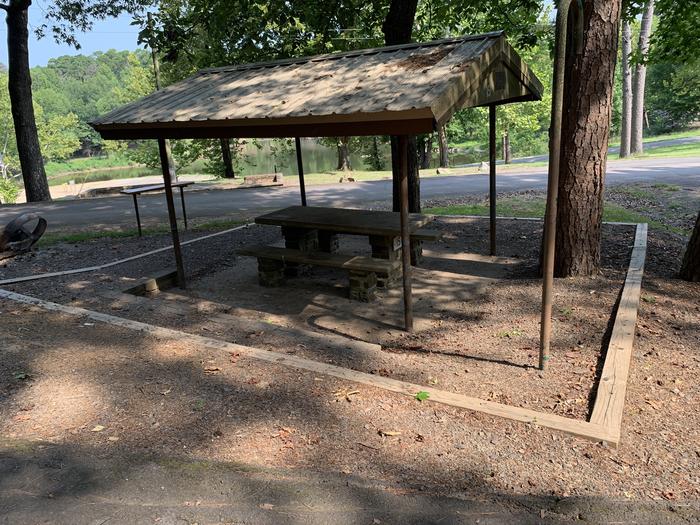 Table area.A photo of Site 15 of Loop QCOV at QUARRY COVE with Picnic Table, Electricity Hookup, Fire Pit, Shade, Lantern Pole, Water Hookup