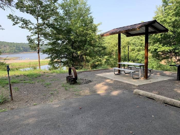 A photo of Site 05 of Loop QCOV at QUARRY COVE with Picnic Table, Electricity Hookup, Fire Pit, Lantern Pole, Water Hookup