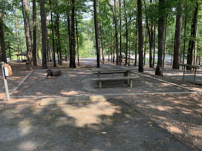 A photo of Site 12 of Loop QCOV at QUARRY COVE with Picnic Table, Electricity Hookup, Fire Pit, Shade, Water Hookup
