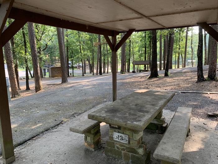 View from picnic table toward entry roadway.A photo of Site 13 of Loop QCOV at QUARRY COVE with Picnic Table, Electricity Hookup, Fire Pit, Shade, Lantern Pole, Water Hookup