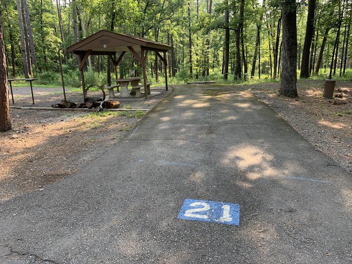 A photo of Site 21 of Loop QCOV at QUARRY COVE with Picnic Table, Electricity Hookup, Fire Pit, Shade, Lantern Pole, Water Hookup