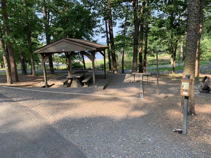 A photo of Site 09 of Loop QCOV at QUARRY COVE with Picnic Table, Electricity Hookup, Fire Pit, Shade, Lantern Pole, Water Hookup