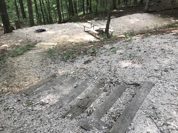  A nice tent pad area with fire ring and picnic table lantern pole, very flat very level has 16 steps going down to the parking area