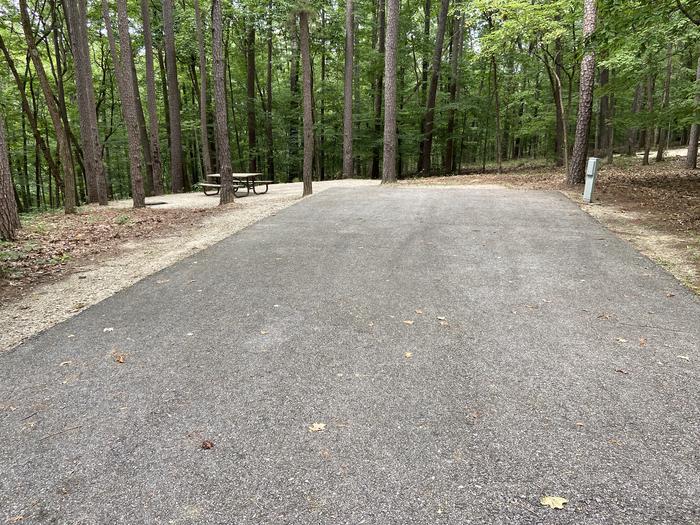 A photo of Site 187 of Loop PINE at HARDIN RIDGE with Picnic Table, Electricity Hookup, Fire Pit, Shade, Tent Pad, Lantern Pole. Paved parking area.