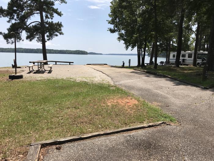 A photo of Site 112 of Loop LOOJ at Holiday (Georgia) with Picnic Table, Electricity Hookup, Tent Pad, Waterfront, Lantern Pole, Water Hookup