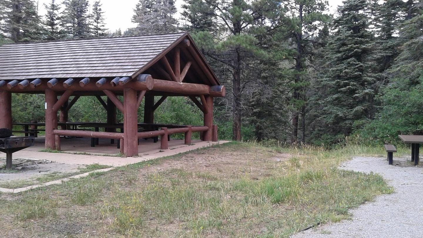 This is a picture of a pavilion in the trees Balsam Glade Group Site Pavilion