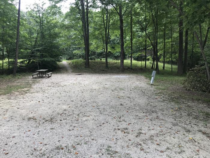 A photo of Site 143 of Loop WOAK at HARDIN RIDGE with Picnic Table, Electricity Hookup, Fire Pit, Shade, Tent Pad, Lantern Pole right next to a nice pond
