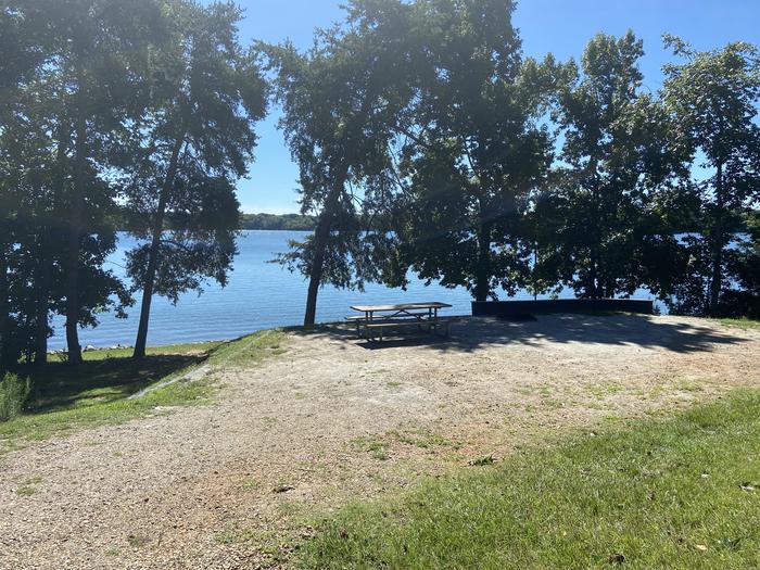 A photo of Site 55 of Loop SPRINGFIELD  at SPRINGFIELD with Picnic Table, Electricity Hookup, Fire Pit, Shade, Tent Pad, Waterfront, Lantern Pole, Water Hookup