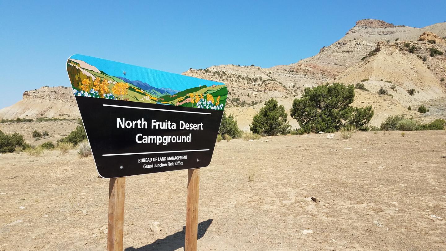 North Fruita Desert Campground signNorth Fruita Desert Campground sign at entrance to campground.  Bookcliff mountain range in background. 