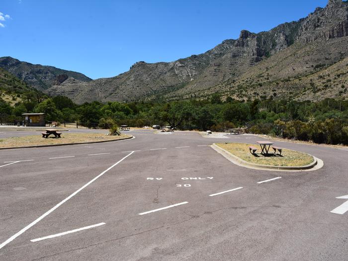 RV Campsite 30 is a paved, pull-through site.  This site is an end space and offers a small area with a picnic table.  The background offers mountain views.RV Campsite 30 is a paved, pull-through site.  This site is an end space and offers a small area with a picnic table.