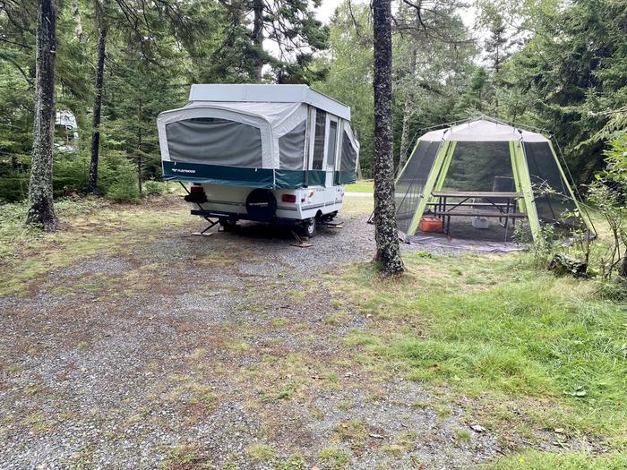 Site C34Travel trailer in C34 with screen tent over picnic table