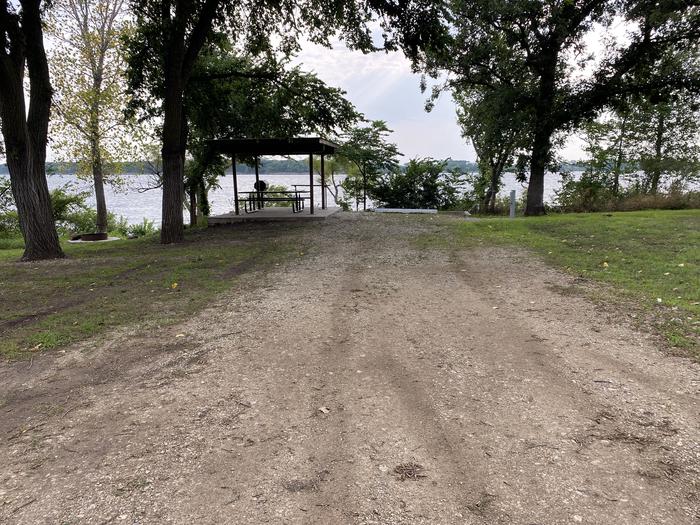 A photo of Site 017 of Loop RCOV at RICHEY COVE with Picnic Table, Electricity Hookup, Fire Pit, Shade, Waterfront