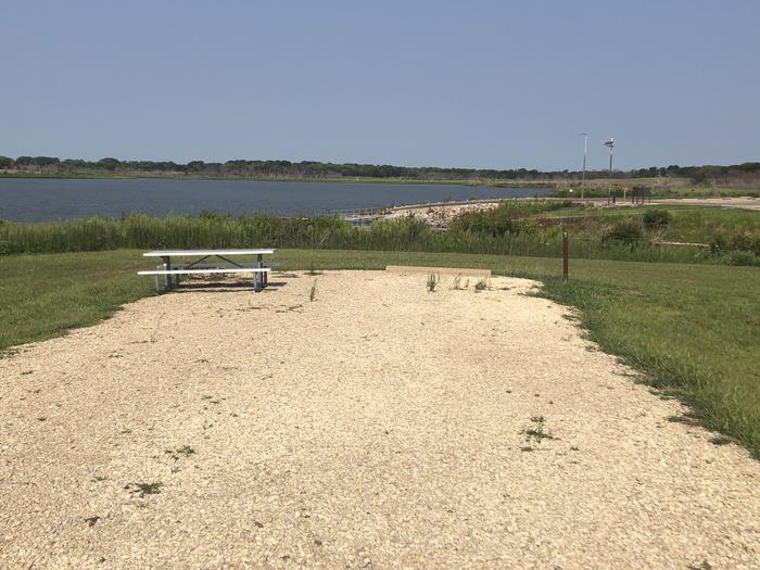 A photo of Site A018 of Loop A at CURTIS CREEK with Picnic Table, Electricity Hookup, Fire Pit, Waterfront, Water Hookup