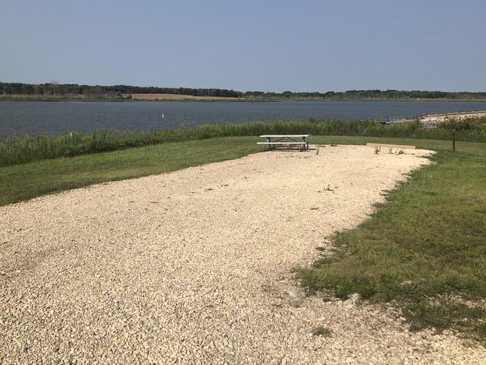 A photo of Site A018 of Loop A at CURTIS CREEK with Picnic Table, Electricity Hookup, Fire Pit, Waterfront, Water Hookup