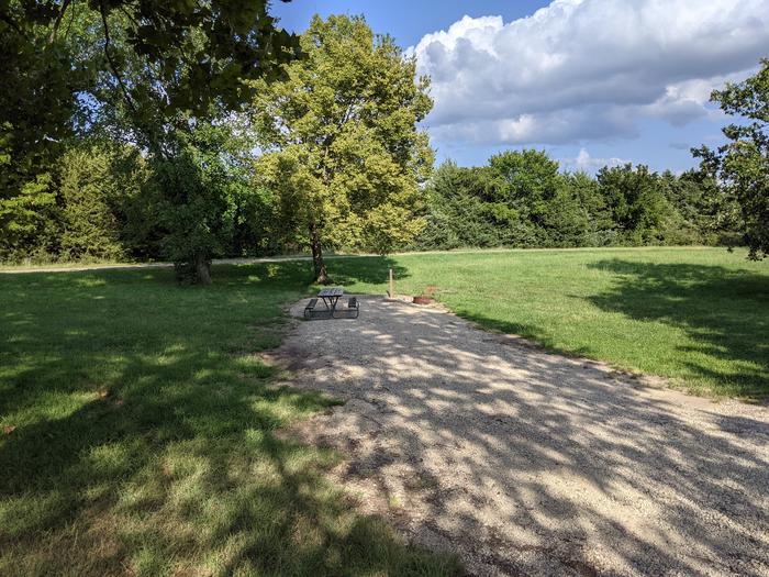 A photo of Site 15 of Loop A at Timber Creek Park with Picnic Table, Fire Pit, Shade