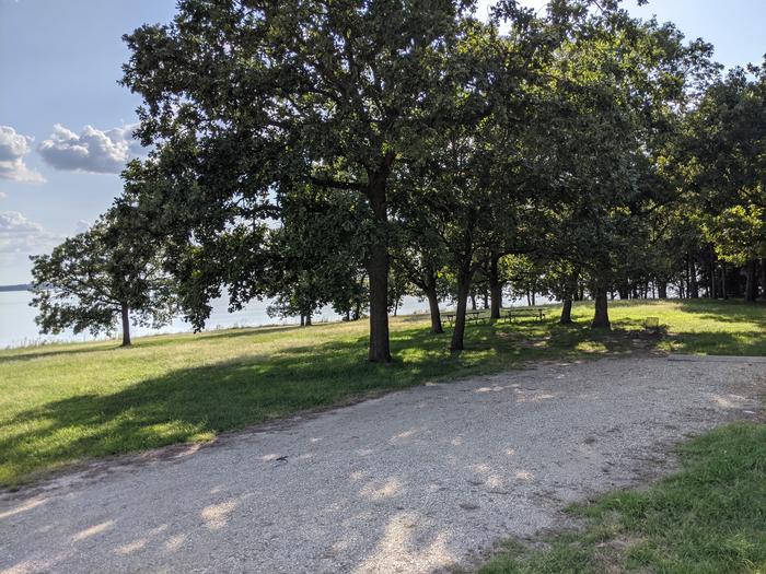 A photo of Site 18 of Loop A at Timber Creek Park with Picnic Table, Fire Pit, Shade, Waterfront