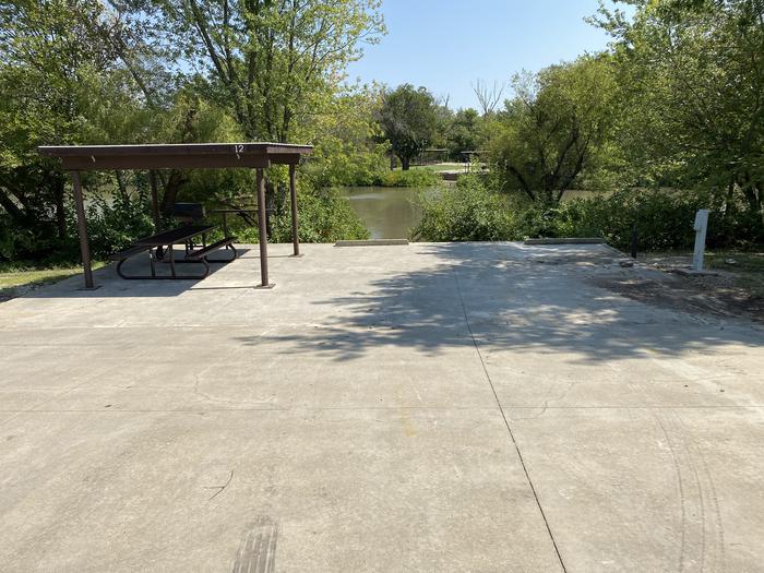 A photo of Site 012 of Loop SFET at SANTA FE TRAIL with Picnic Table, Electricity Hookup, Fire Pit, Shade, Waterfront, Water Hookup