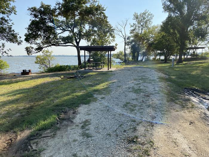 A photo of Site 020 of Loop RCOV at RICHEY COVE with Picnic Table, Electricity Hookup, Fire Pit, Shade, Waterfront