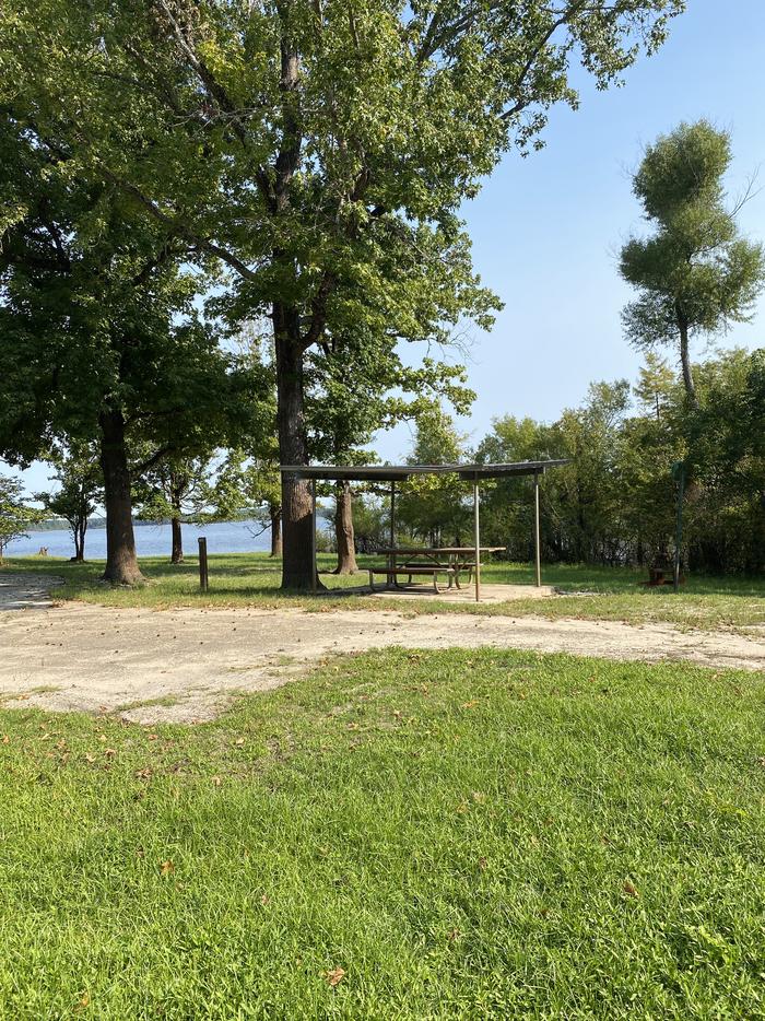 A photo of Site 061 of Loop B at MILL CREEK (TEXAS) with Picnic Table, Electricity Hookup, Fire Pit, Shade, Lantern Pole, Water Hookup, Lean To / Shelter