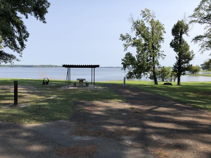 A photo of Site 070 of Loop C at MILL CREEK (TEXAS) with Picnic Table, Electricity Hookup, Fire Pit, Waterfront, Lantern Pole, Water Hookup