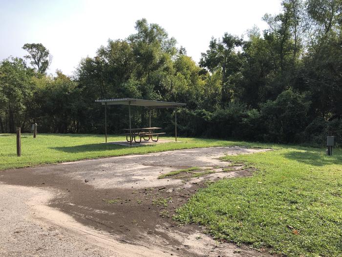 A photo of Site 060 of Loop B at MILL CREEK (TEXAS) with Picnic Table, Electricity Hookup, Fire Pit, Shade, Water Hookup
