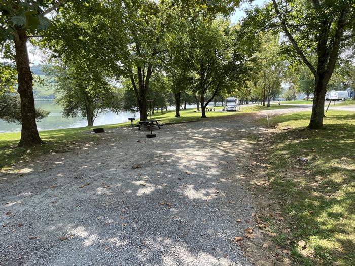 A photo of Site 080 of Loop LAKE at DEFEATED CREEK PARK with Picnic Table, Electricity Hookup, Fire Pit, Shade, Waterfront, Lantern Pole, Water Hookup