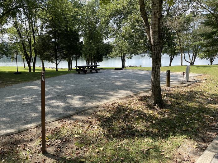 A photo of Site 057 of Loop LAKE at DEFEATED CREEK PARK with Picnic Table, Electricity Hookup, Sewer Hookup, Fire Pit, Shade, Full Hookup, Waterfront, Water Hookup