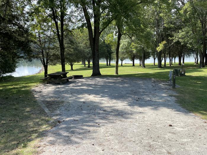 A photo of Site 068 of Loop LAKE at DEFEATED CREEK PARK with Picnic Table, Electricity Hookup, Sewer Hookup, Fire Pit, Shade, Full Hookup, Waterfront, Water Hookup