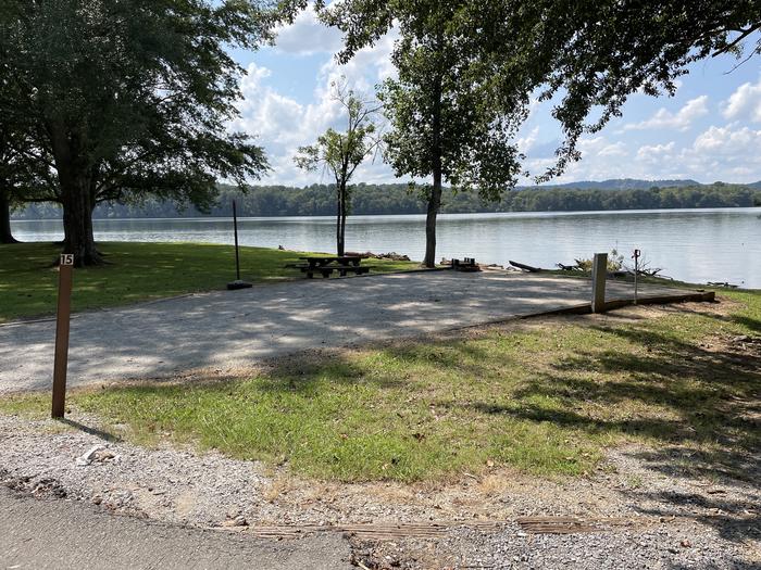 A photo of Site 015 of Loop LAKE at DEFEATED CREEK PARK with Picnic Table, Electricity Hookup, Fire Pit, Shade, Waterfront, Lantern Pole, Water Hookup