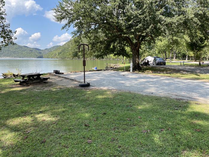 A photo of Site 015 of Loop LAKE at DEFEATED CREEK PARK with Picnic Table, Electricity Hookup, Fire Pit, Shade, Waterfront, Lantern Pole, Water Hookup