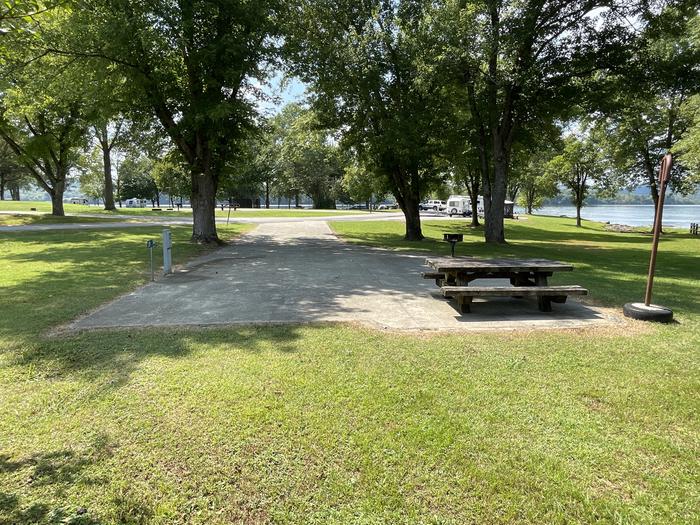 A photo of Site 006 of Loop LAKE at DEFEATED CREEK PARK with Picnic Table, Electricity Hookup, Fire Pit, Shade, Lantern Pole, Water Hookup