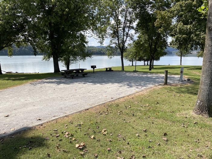 A photo of Site 049 of Loop LAKE at DEFEATED CREEK PARK with Picnic Table, Electricity Hookup, Sewer Hookup, Fire Pit, Shade, Full Hookup, Waterfront, Lantern Pole, Water Hookup