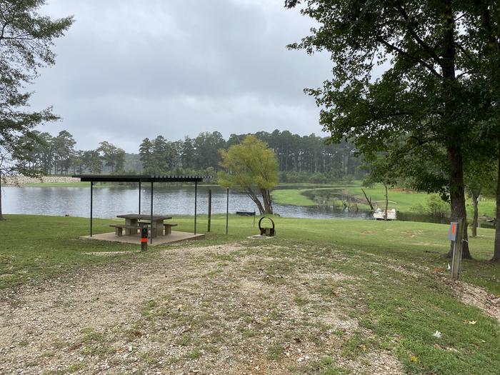 A photo of Site 27 of Loop LOOB at RAYBURN with Picnic Table, Electricity Hookup, Fire Pit, Waterfront, Lantern Pole, Water Hookup, Lean To / Shelter