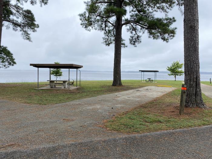 A photo of Site 42 of Loop LOOB at RAYBURN with Picnic Table, Electricity Hookup, Fire Pit, Shade, Waterfront, Lantern Pole, Water Hookup, Lean To / Shelter