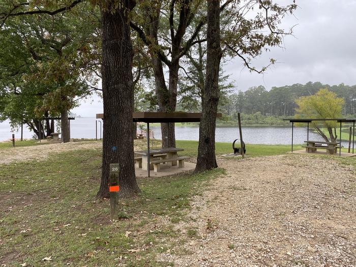 A photo of Site 26 of Loop LOOB at RAYBURN with Picnic Table, Electricity Hookup, Fire Pit, Shade, Waterfront, Lantern Pole, Water Hookup, Lean To / Shelter
