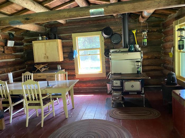 Kenck Cabin InteriorCabin interior with table, chairs, cookstove