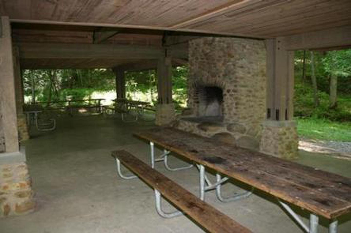 Greenbrier Picnic Pavilion showing picnic tables and charcoal only fireplacepicnic table located in pavilion