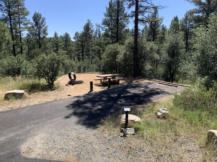 A photo of Site 03 of Loop A at LYNX CAMPGROUND with Picnic Table, Fire Pit, and full view of back-in parking. 