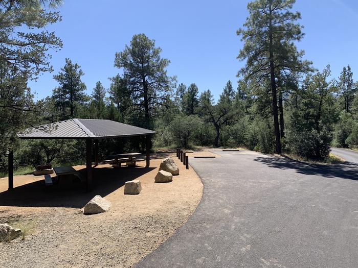 A photo of Site 05 of Loop B at LYNX CAMPGROUND with Picnic Table, Fire Pit, Shade. Full view of two RV back-in parking spots. 