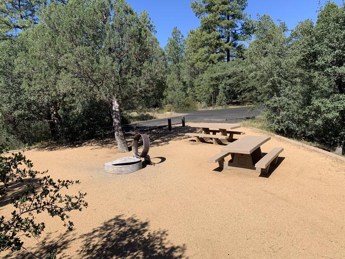 A photo of Site 22 of Loop E at LYNX CAMPGROUND with  2 Picnic Tables, Fire Pit. Parking are in background. 