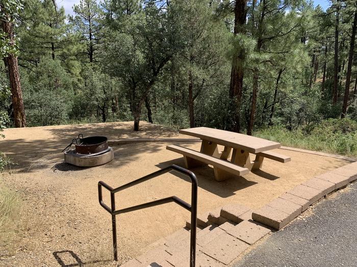 A photo of Site 12 of Loop C at LYNX CAMPGROUND with Picnic Table, Fire Pit with 4
5 steps down to two-tier campsite. 