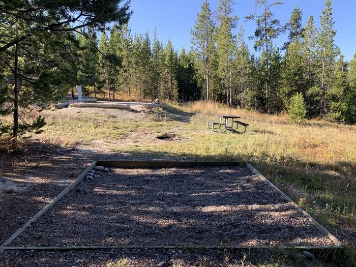 A photo of Site 12 of Loop 1 at Signal Mountain Lodge Campground with Picnic Table, Electricity Hookup, Fire Pit, Food Storage, Tent Pad, Waterfront