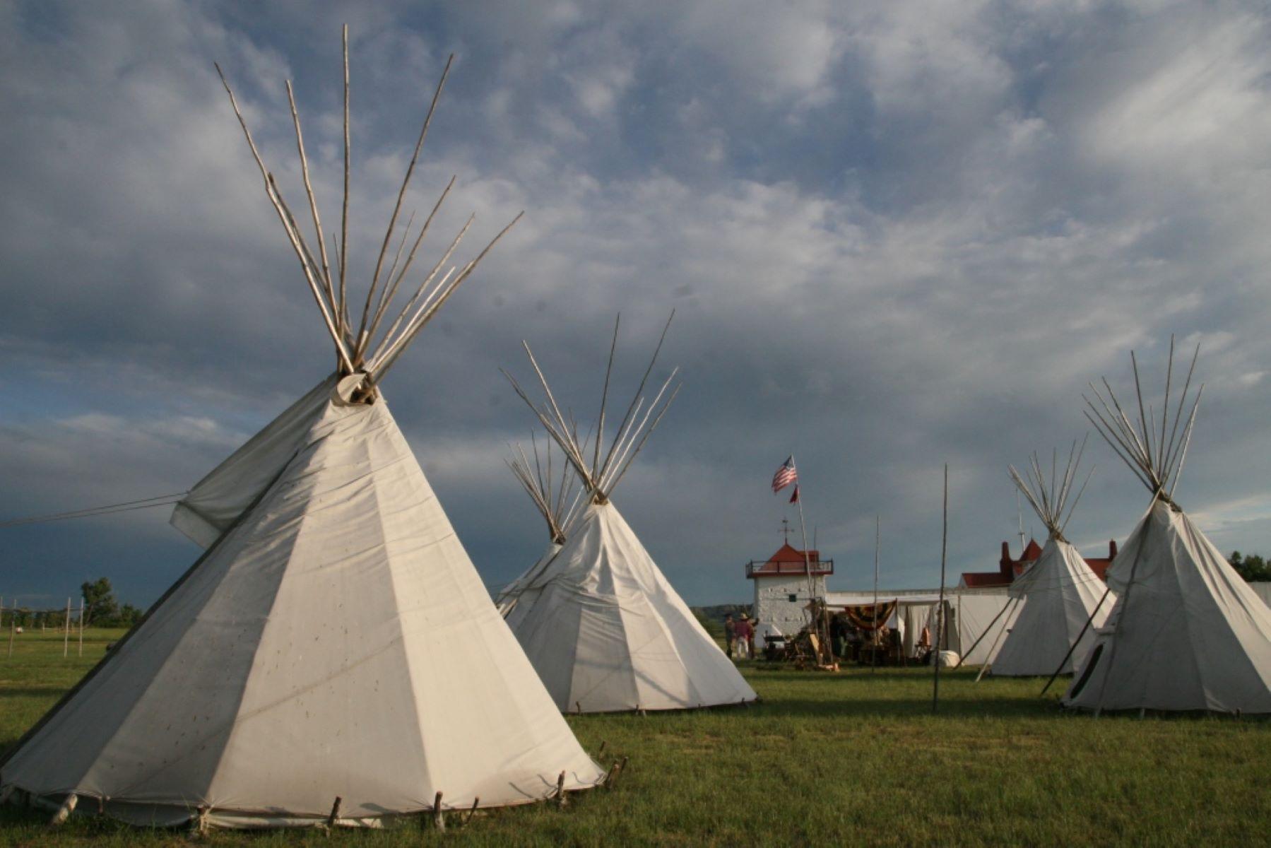 Tipis fill the fields around at Fort Union