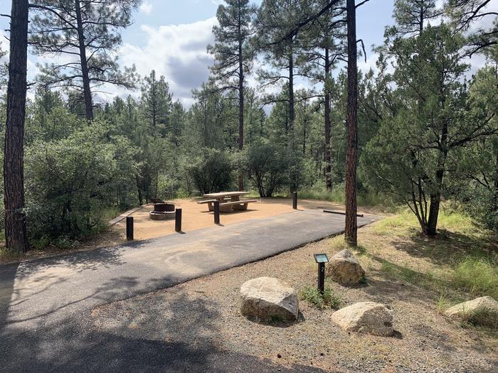 A photo of Site 02 of Loop A at LYNX CAMPGROUND with Picnic Table, Fire Pit and back-in driveway. 