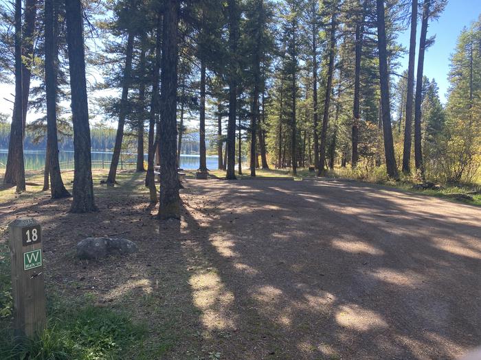 A photo of Site 018 of Loop C - BAY at HOLLAND LAKE CAMPGROUND with Picnic Table, Fire Pit, Waterfront